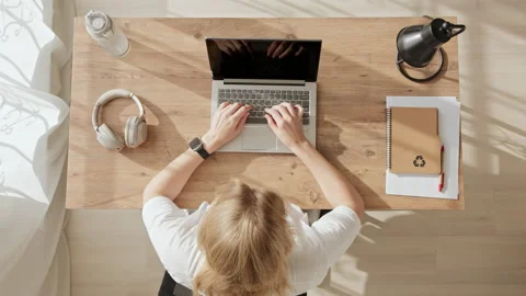 Top down view of girl working at computer and raising her hands up with emotion Stock Footage 234651882