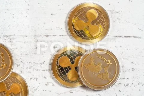 Top down view, golden XRP - ripple cryptocurrency - coins on white stone board Stock Photos