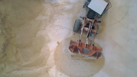 Top Down View of Grader Moving Clay Soil in Ceramic Factory Warehouse Stock Footage 166696736