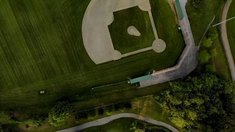 A top down view of a green baseball field in between trees that is currently Stock Footage 108896429