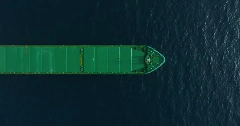 Top-down view of green bulk carrier anchored at sea on calm water during the day Stock Footage 265111342