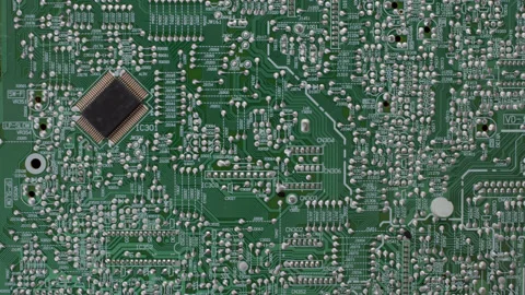 Top down view of green microchip of complex equipment. Many soldered paths along Stock Footage 218600983