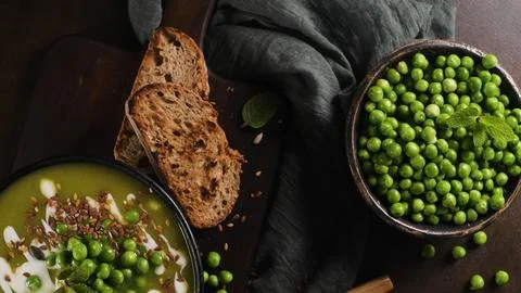 Top Down View of Green Pea Soup with Toasted Bread and Fresh Peas in a Bowl Stock Photos