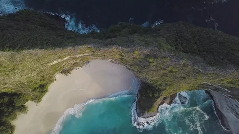 Top down view of the green ridge hides amazing sand beach with turquoise waves Stock Footage 101670361