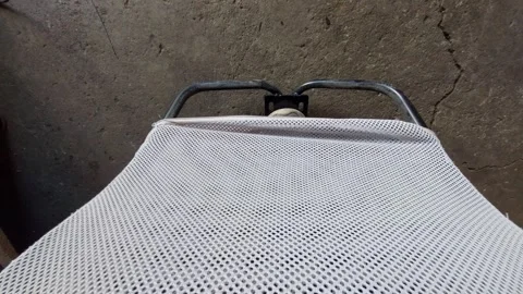 Top down view of a grey mesh sunbed or garden chair Stock Footage 334569375