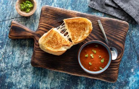 Top down view of a grilled cheese sandwich with tomato soup, ready for eating. Stock Photos