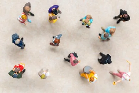Top-down view of a group of miniature people showing different clothing and.. Foto stock