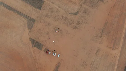 Top down view of group of parachutist park and preparing paramotor to fly Video stock 116565654