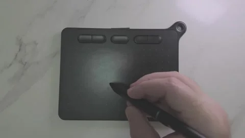 Top Down View of a Hand Drawing a Heart on a Digital Tablet Stock Footage 345132817