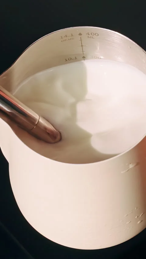 Top Down View Of Hand Holding Milk Pitcher While Steam Wand Froths Milk Creating Stock Footage 331415862