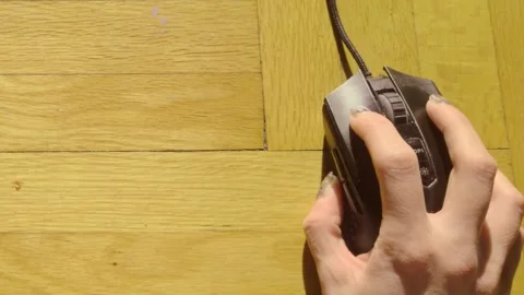 Top Down View of Hand Navigating and Clicking Wired Mouse on Wood Floor Stock Footage 327508103