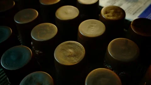 Top-down view of handmade clay cups placed upside down on a metal rack. Stock Footage 328925151