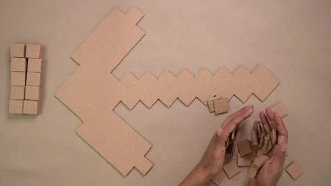 Top down view of hands crafting cardboard patterns Stock Footage 327695239