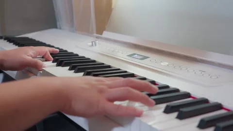 Top Down View of Hands Playing Electronic Piano Keyboard Video stock 336294974