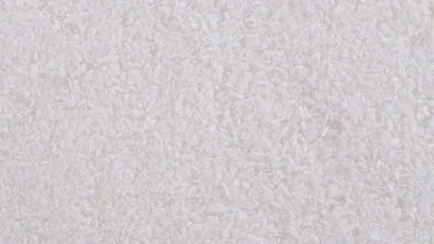 Top down view. Heap of dried shredded coconut. Macro texture of coconut flakes 動画素材 296518069