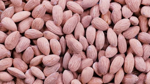 Top down view, heap of fresh almonds. Natural brown tones and textured shell Stock Footage 296520256