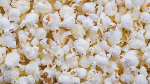 Top down view. Heap of fresh popped salty popcorn grains with crispy Stock Footage 296524635