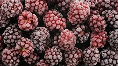 Top down view. Heap of frozen black and red raspberries covered with frost. Stock Footage 293690447