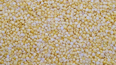 Top down view. Heap of raw uncooked yellow lentils, slider shot. Stock Footage 296525107