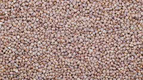 Top down view. Heap of uncooked dry buckwheat groats. Slider shot. Stock Footage 296569634