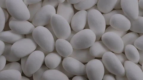 Top down view. Heap of white chocolate covered almond nuts. Slider shot Stock Footage 296519641