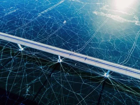 Top down view of a highway bridge spanning over a frozen lake. Stock Photos