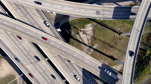 Top down view of highway intersection with traffic flowing on several layer.. Stock Footage 322895619