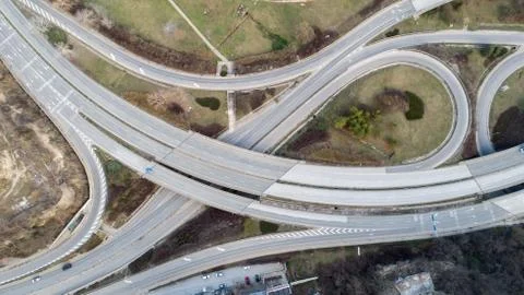 Top down view of highway multi level junction road with moving cars. View of Stock Photos