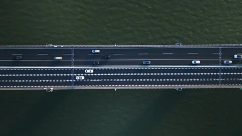 Top down view of highway traffic flows in both directions on a wide bridge 스톡 동영상 309094424