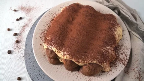 Top down view of homemade tiramisu cake dusted with cocoa powder on a rustic tab Stock Footage 340143851