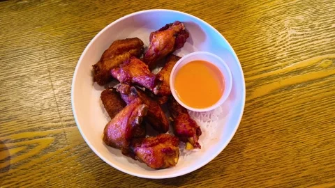 Top down view of hot freshly fried grilled cooked chicken wings with creamy.. Video stock 318129989
