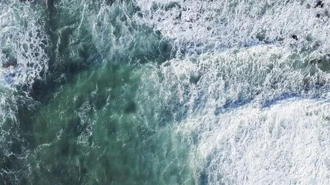 Top down view on huge and powerful waves cover rocky coast of the Atlantic Ocean Stock Footage 119180180