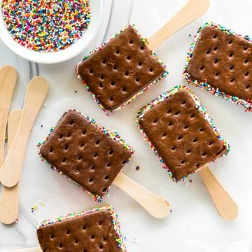 Top down view of ice cream sandwich pops with colourful sprinkles. Stock Photos