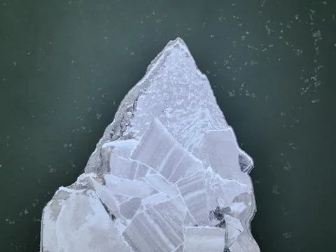 Top Down View of Ice Sheet Floating in Dark Green Water Stock Photos