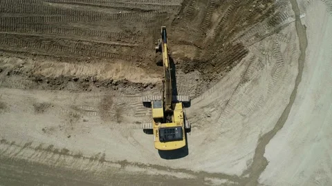 Top-Down View . An Industrial Excavator On An Open Road Section Digs The Ground Stock Footage 136636255