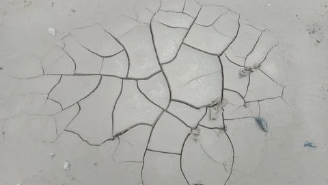 Top Down View of Isolated Cracked Clay Mud Patch on Smooth Ground Stock Photos