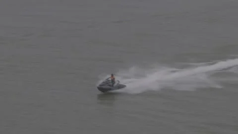 Top Down View Of Jet Ski Rider In Green Vest Making Turn Stock-Footage 343546795
