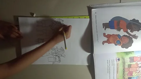 Top-down view of a kid holding a ballpoint pen and sketching on paper Stock Footage 344424769