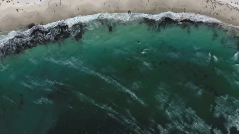Top down view of a kite surfer riding some waves at Camps Bay beach Stock Footage 170725252
