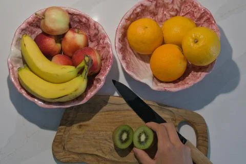 Top Down View of Kiwi Preparation with Mixed Fruit Bowls Stock Photos