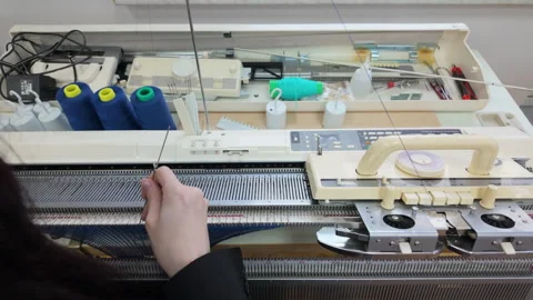 Top down view of a knitting workstation, including multiple spools of yarn, Видео 335348574