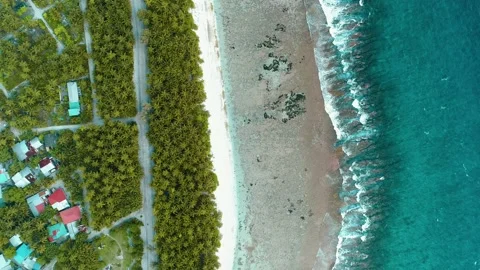 A top down view of the lagoon and the tropical palm trees with the nearby local  Stock-Footage 136901615