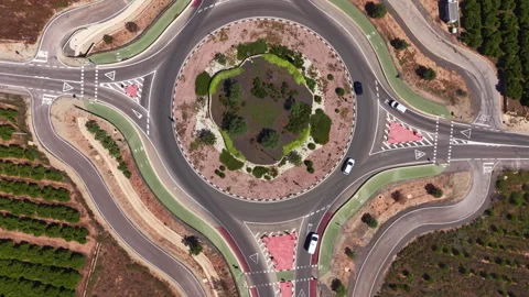 Top-down view of a large roundabout with a green landscaped central island Stock Footage 341468341