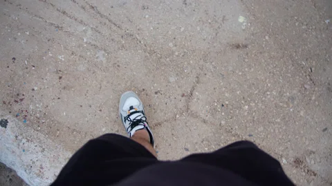 Top down view of legs in sneakers walking along city street. Sunny day for walks Stock Footage 222011691