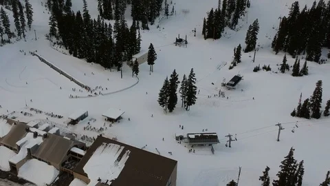 Top down view of lift and people moving at a ski resort. Stock Footage 100695392