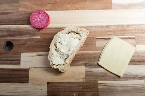 Top-down view of loaf of bread on wooden background  rustic food scene Stock Photos