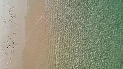 Top down view low altitude of white sandy beach. Transparent sea water. Stock Footage 130140248