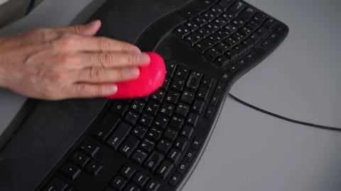 Top down view of male hands pressing sticky pink slime into dirty black Stock Footage 342758089