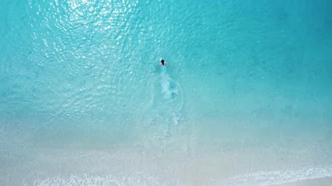 Top down view of man running and diving into blue sea. Stock Footage 155790179