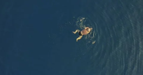 Top Down View Man Swimming in Clear Blue Sea Water in Chalkidiki Stock Footage 342219495